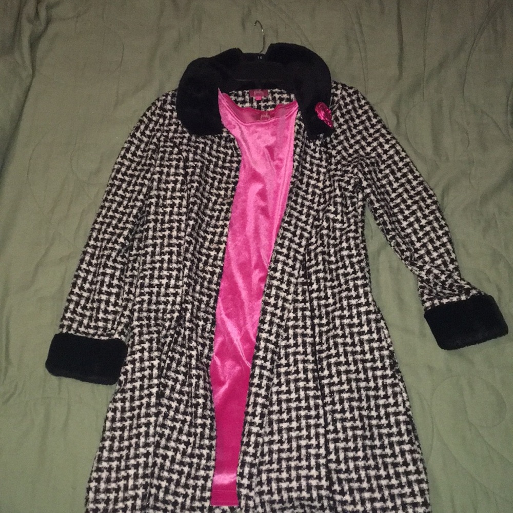 A pink dress with a black and white sweater